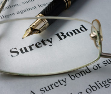 Page of newspaper with words surety bond.